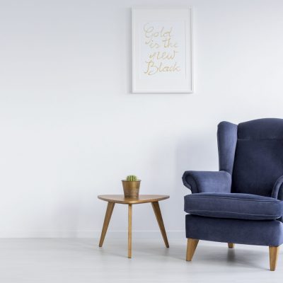Cozy space with armchair in simple white lounge