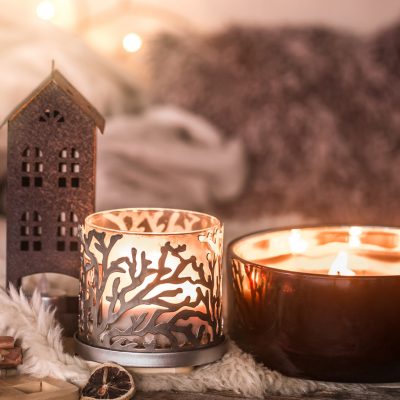 home still life in the interior with beautiful candles, on the background of a cozy home decor, the concept of home items