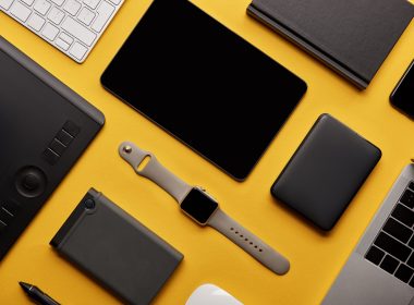 flat lay with different wireless devices on yellow surface